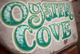 The Oyster Cove sign